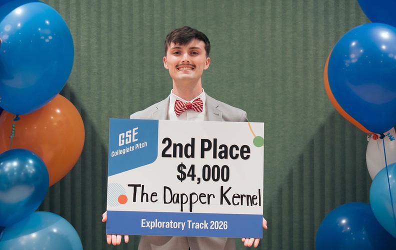 CU Student Bryce Osborne stands with his second-place award while at the Governor's School for Entrepreneurs Collegiate Pitch Competition