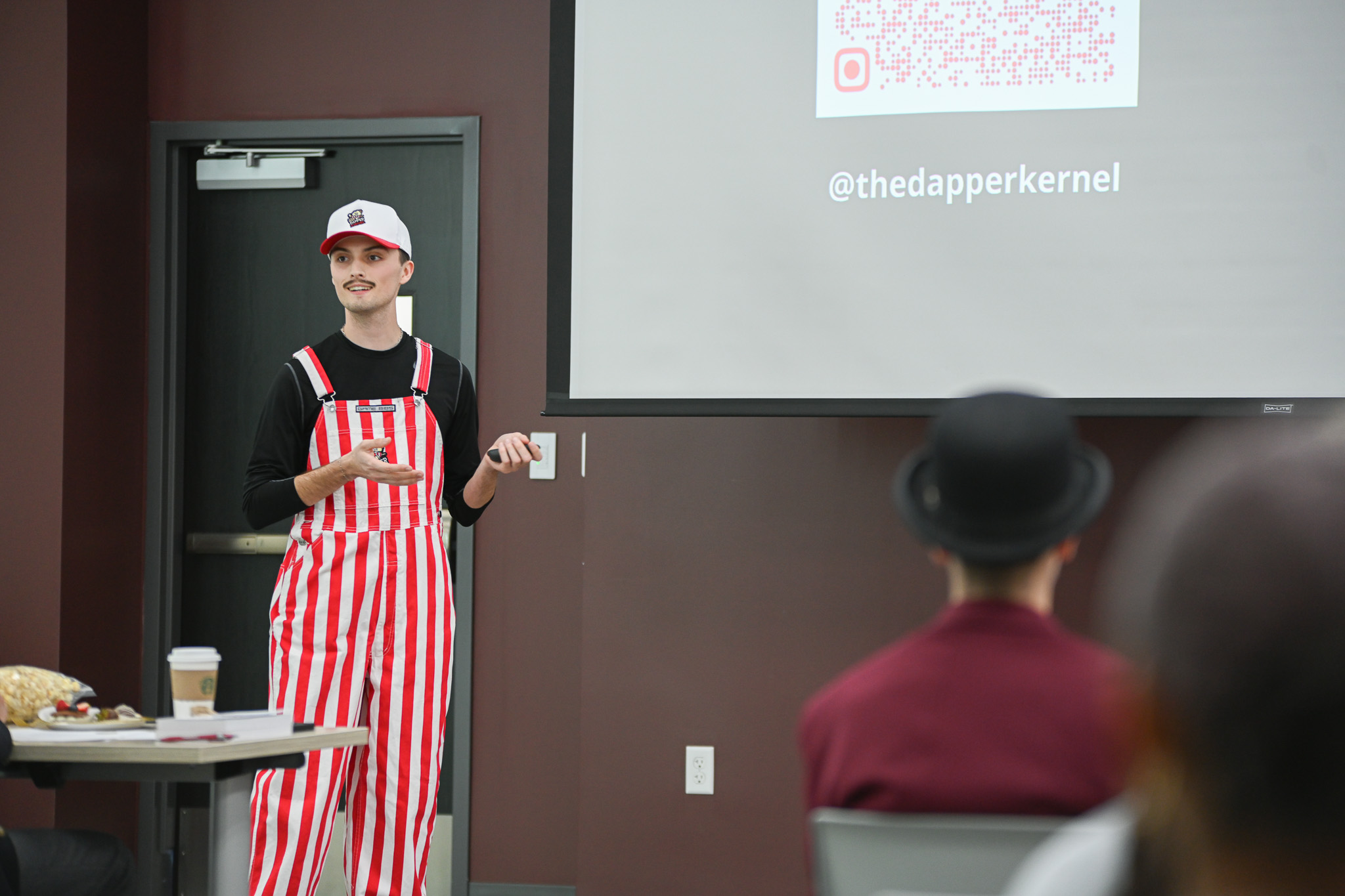 Bryce Osborne presents his business “The Dapper Kernel to a panel of judges at the CU E-Club pitch competition