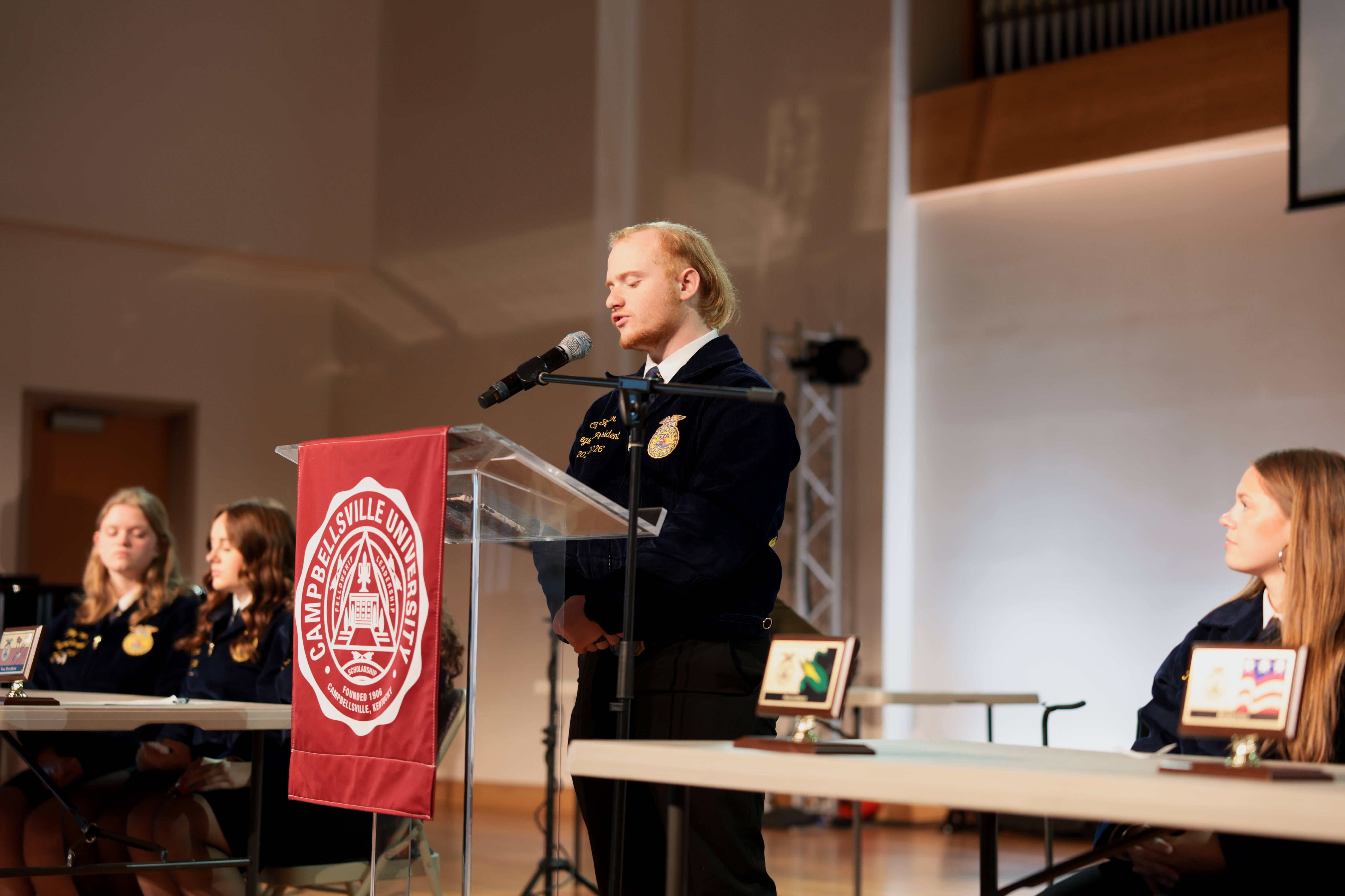 2025-2026 Lake Cumberland Regional President, Caleb Feather of Taylor County, Ky., speaks to fellow members at the regional FFA day at Campbellsville University.