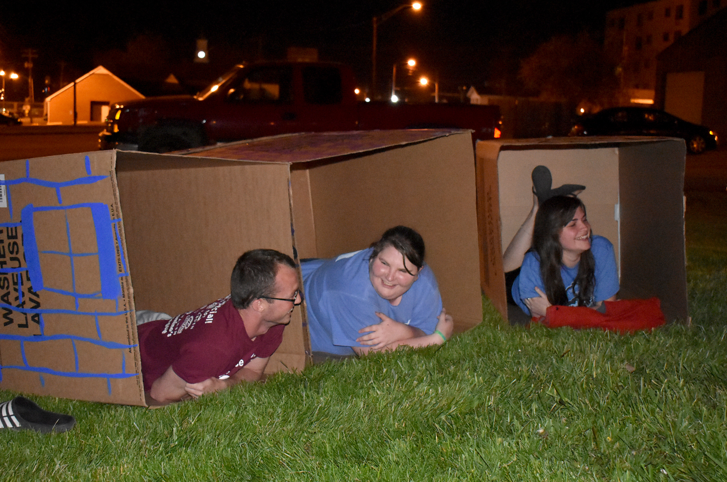 From left, Campbellsville University students Austin Tucker, Kendra Polston and Christy Ingram settle in their cardboard boxes for Cardboard Nation. (CU Photo by Alexandria Swanger)
