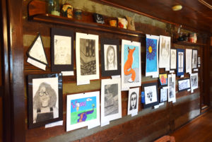 Students could enter the Juried Art Show in seven different categories including: painting, drawing, photography, graphic design, mixed media, ceramics and sculpture. All works were displayed in the Turner Log Cabin for students to see what their peers had submitted. (CU Photo By Kasey Ricketts) 