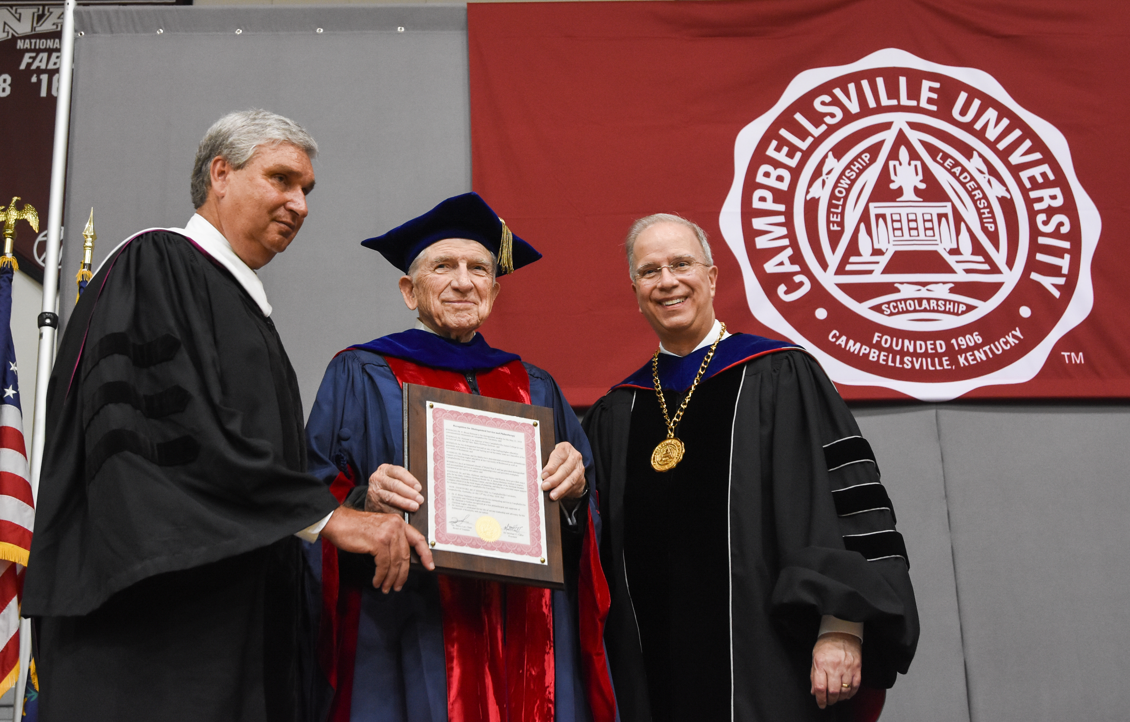 Dr.E. Bruce Heilman, chancellor of the University of Richmond, was the commencement speaker at both 9 a.m. and noon commencements. He was also awarded a plaque for Distinguished Service and Philanthropy by Henry Lee, chair of the CU Board of Trustees, left, and Dr. Michael V. Carter, president, on right. (Campbellsville University Photo by Joshua Williams)