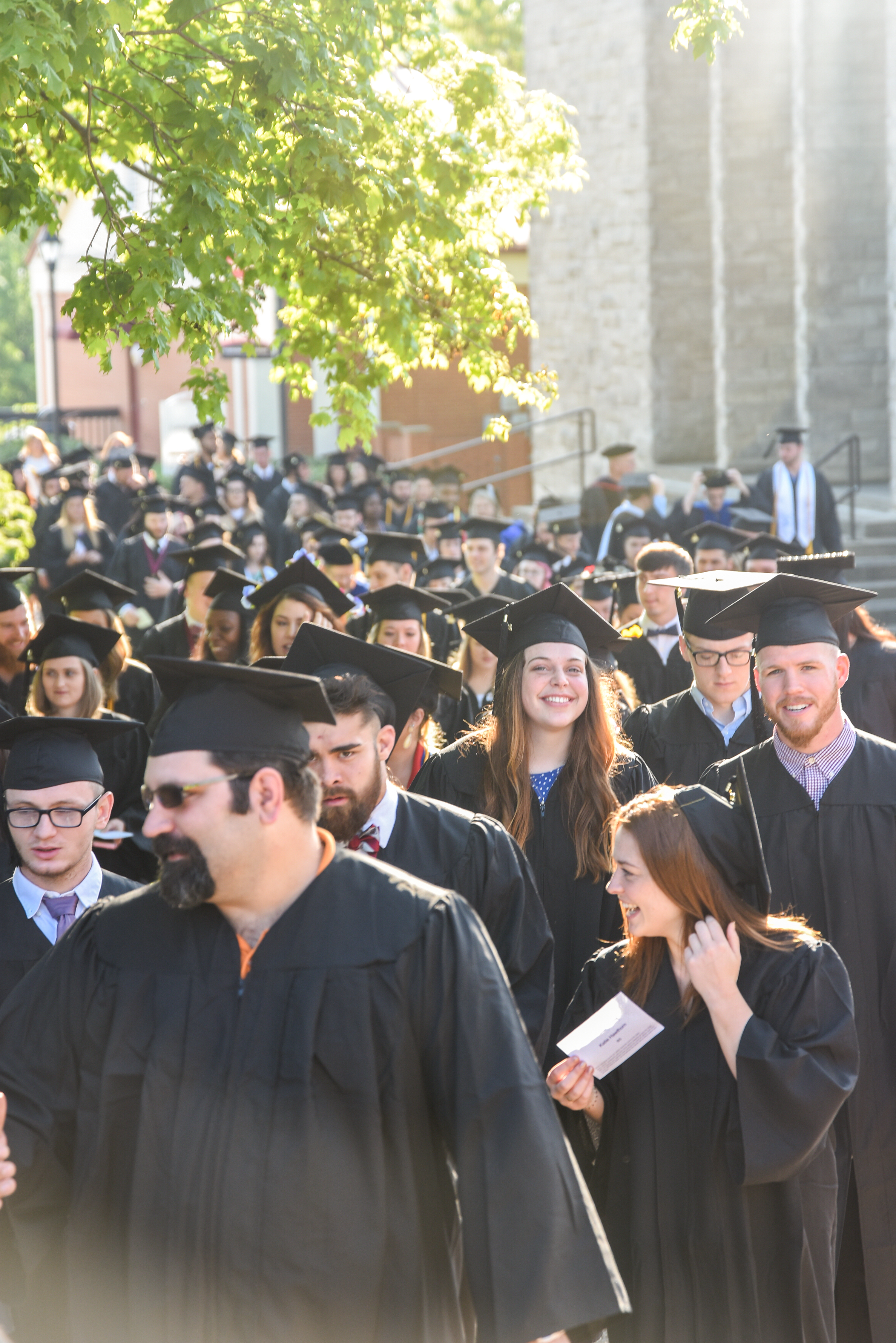 Campbellsville University graduates take part in the traditional “Senior Walk” on campus, before their graduation ceremony. (Campbellsville University Photo by Joshua Williams)