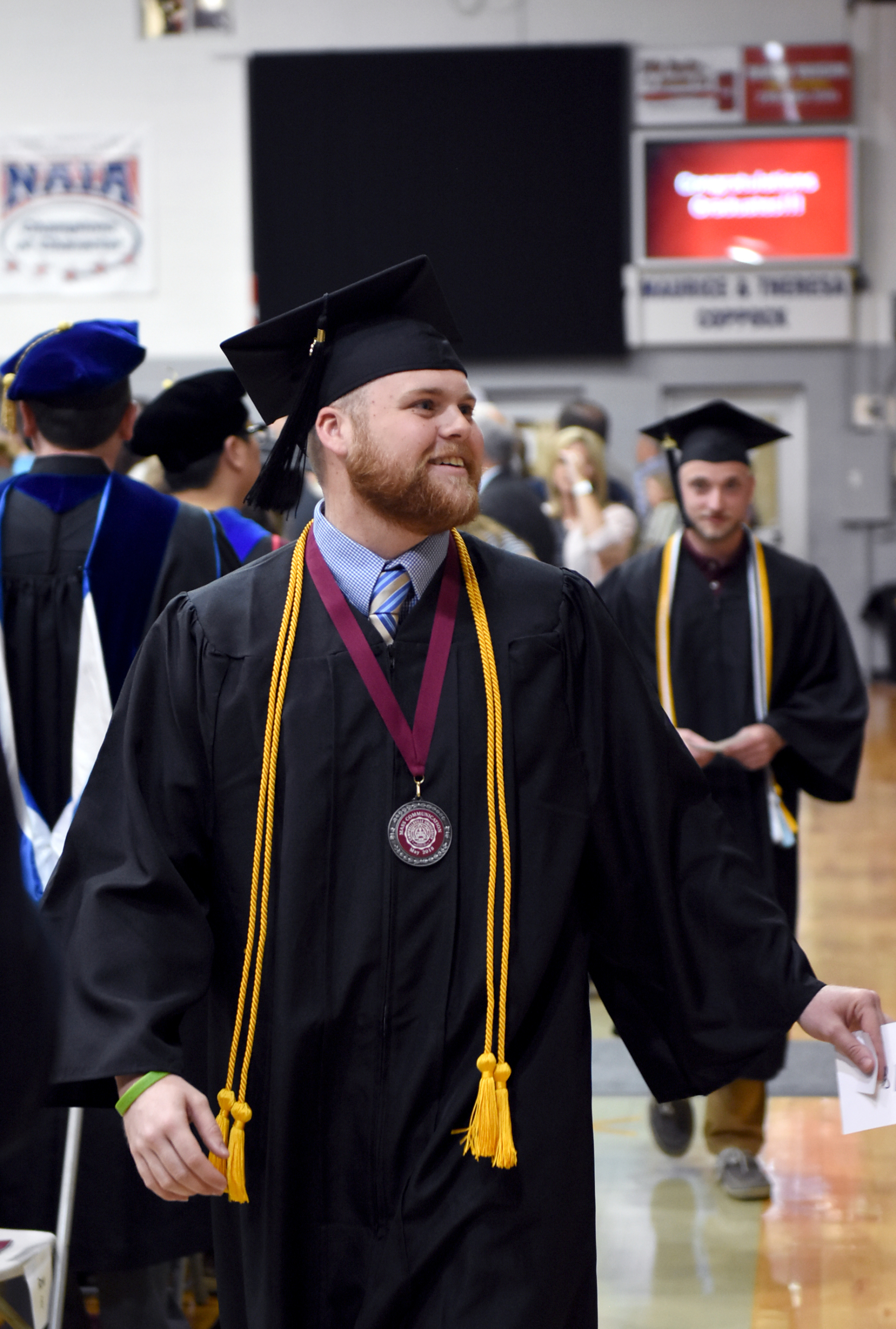 Alex Meade -- Alexander Meade acknowledges family and friends as he enters the Powell Gymnasium for the 2018 commencement ceremony. (CU Photo by Ariel C. Emberton)