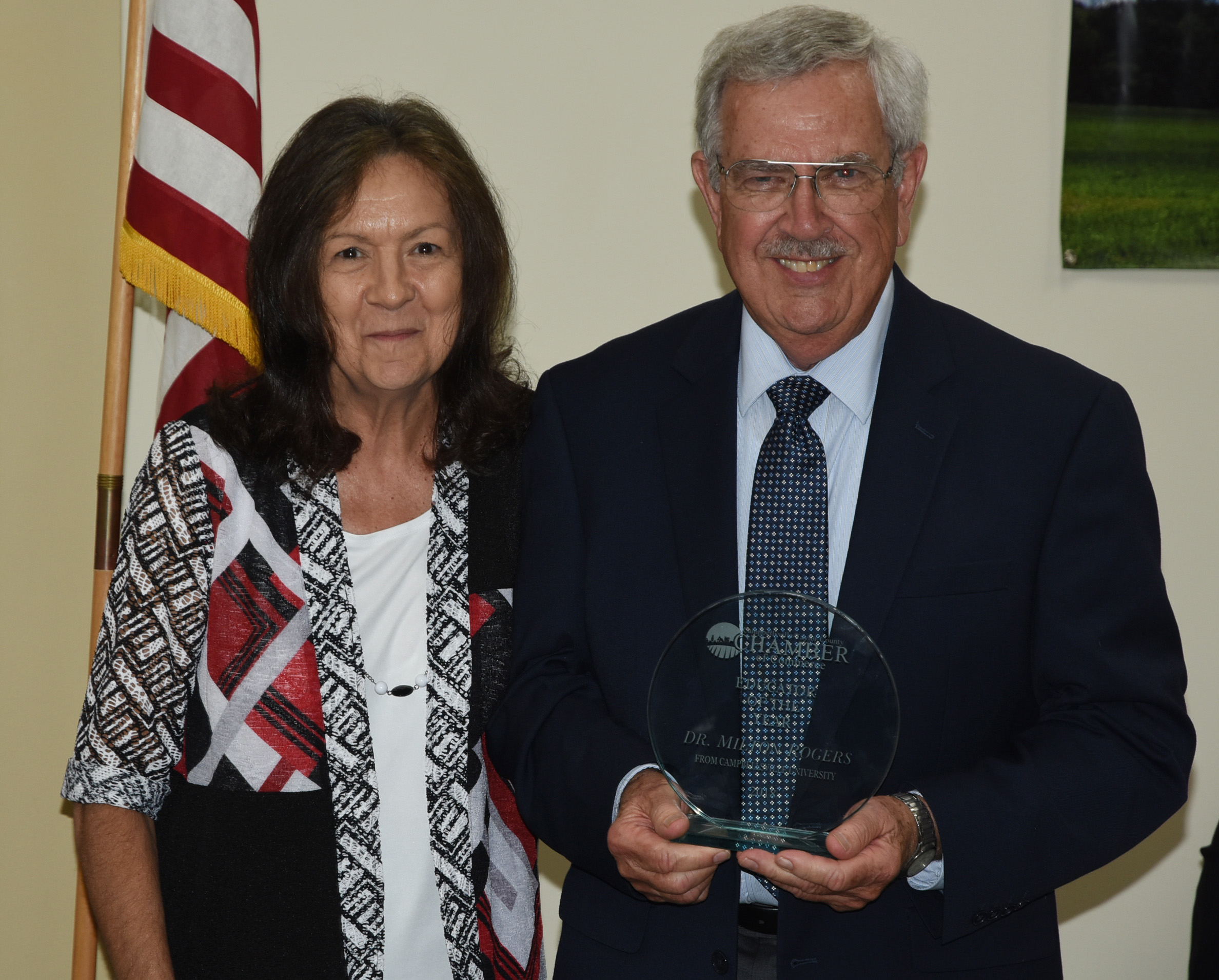 Dr. Milton Rogers, right, receives the Campbellsville-Taylor County Chamber of Commerce Educator of the Year Award from Dr. Pat Cowherd, president of the chamber who is dean of the School of Business, Economics and Technology at CU. (CU Photo by Joan C. McKinney)