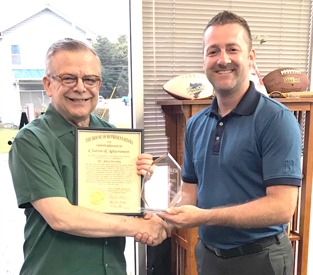 On left, Dr. John Chowning, executive assistant to the president for government, community and constituent relations, receives the Campbellsville-Taylor County Chamber of Commerce Investor of the Year Award from Chad Shively, chamber board of director’s member. (Photo by Erin Estes)