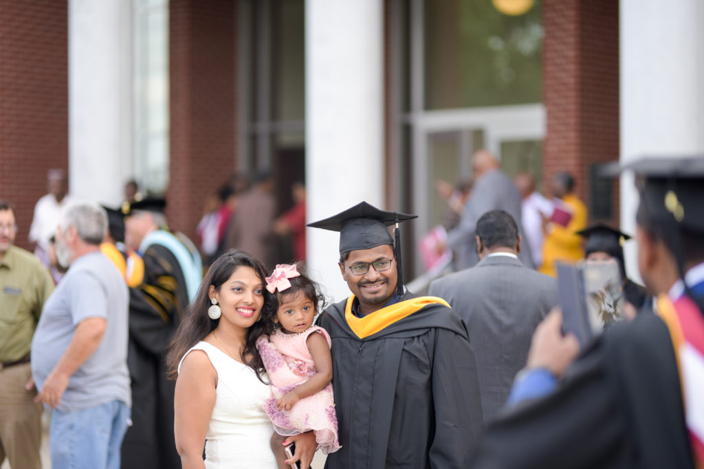 Ram Chandra Prusty of India, gets a photo taken with his wife, Geeta Varanasi, and daughter, Viviktha Prusty, after graduating from Campbellsville University. (Campbellsville University Photo by Joshua Williams)