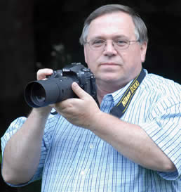Stan McKinney holding camera