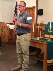 Coach Pete Hedgepath, a member of Saloma Baptist Church, speaks to the congregation about the Bass Fishing Team. 