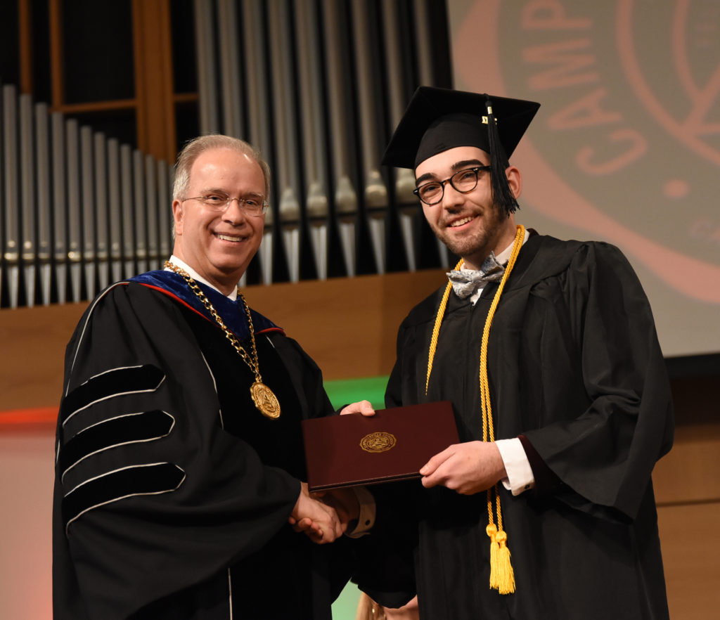 Dalton Bennett of Campbellsville receives his degree at last year’s December 2017 commencement from Dr. Michael V. Carter, president. (Campbellsville University Photo by Joshua Williams)