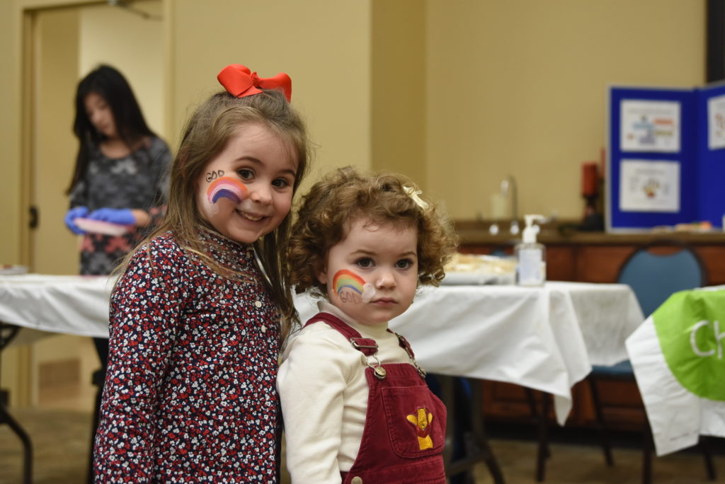 Ariunaa and Kyrea Detherage show off their face paint done by Linda Milbey at the fair. (CU Photo by Whitley Howlett)