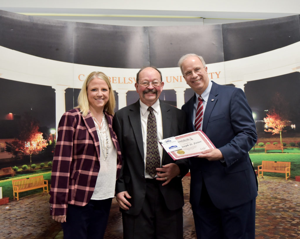 Joe Foster, center, receives a gift for his 35 years of service at Campbellsville University from Dr. Donna Hedgepath, provost and vice president for academic affairs, left, and Dr. Michael V. Carter, president. (CU Photo by Joshua Williams)
