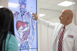 Dr. Dennis Short demonstrates how a touch screen Anatomage Table operates.