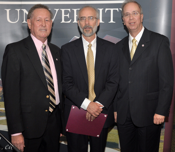 Dr. John Hurtgen, dean of the School of Theology and professor, center, is recognized for 20 years of service to CU from Dr. Frank Cheatham, vice president for academic affairs, left, and Dr. Michael V. Carter, president. (Campbellsville University Photo by Bayarmagnai "Max" Nergui)