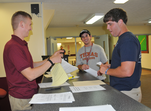 Andrew Jansen, center, a sophomore of Greenbrier, Tenn., and Cody Goodwin, right, a freshman of Portland, Tenn., check into South Hall with Garrett Baker, a senior of Bowling Green, Ky., who serves as a Campbellsville University resident assistant. Jansen and Goodwin are members of the golf team. CU student athletes move in to campus beginning today, Aug. 10. (Campbellsville University Photo by Christina L. Kern)
