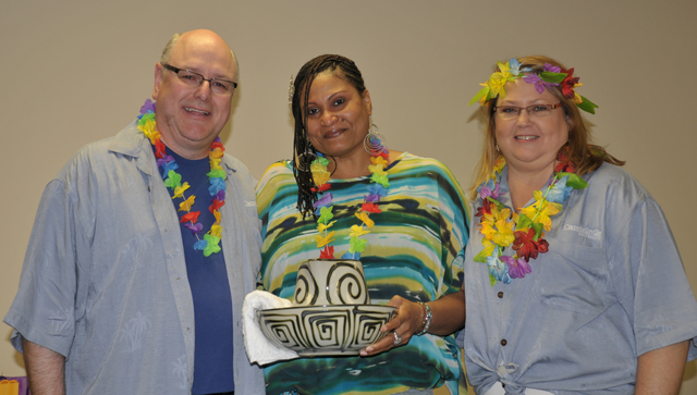 Angeliq Barker of Louisville receives a Servant Leadership Award from Jim Woolums, left, and Kelli Gwilt, right. (Campbellsville University Photo by Linda Waggener)