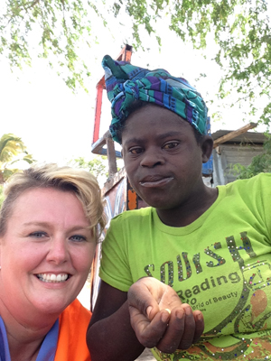 Angie Atwood, assistant professor of nursing  at Campbellsville University, makes a friend in  Haiti.