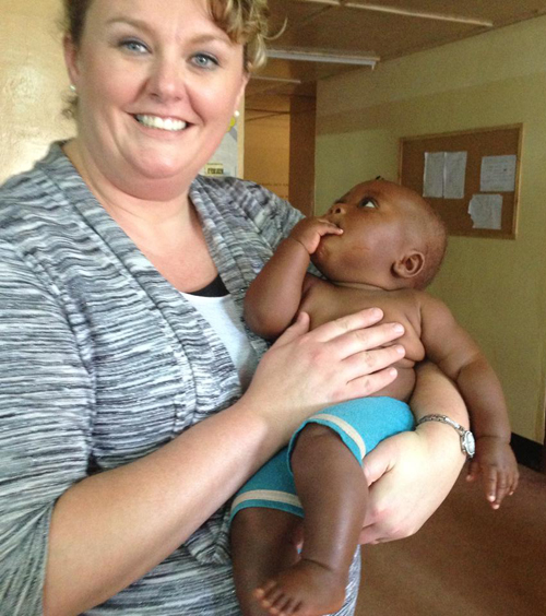 Angie Atwood, assistant professor of nursing at Campbellsville University,  held a baby in Kigoma, Tanzania, during a mission trip during spring break.