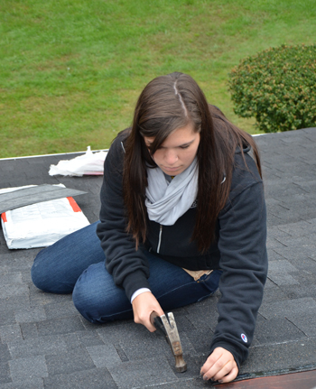 Annie Schakat of Springfield, Ohio, helps repair a roof during Repair Affair with her FIRST CLASS.  (CU Photo by Ashley Wilson)