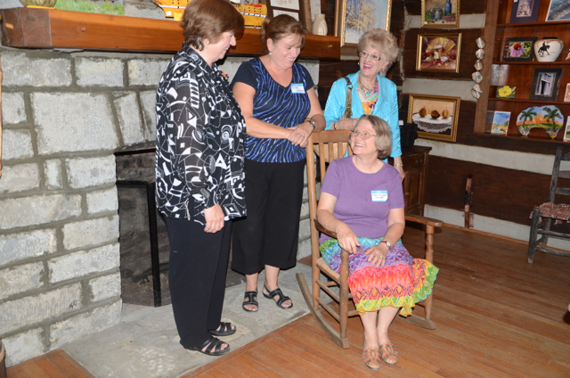 Board members who were involved in the development of the Campbellsville University Log Cabin Art Shop discussed opening day by the fireplace.They are, from left: Linda J. Cundiff, chair of the CU Department of Art; Charlotte Humphress, Margaret Bertram and Cora Renfro. Cundiff, Humphress and Renfro all attended CU in the late 1960s when the art program major was created at then Campbellsville College. Bertram, a member of the Patron of the Visual Arts, was the first to conceive of the idea of the shop in the little log house, according to Cundiff. (Campbellsville University Photo by Linda Waggener)