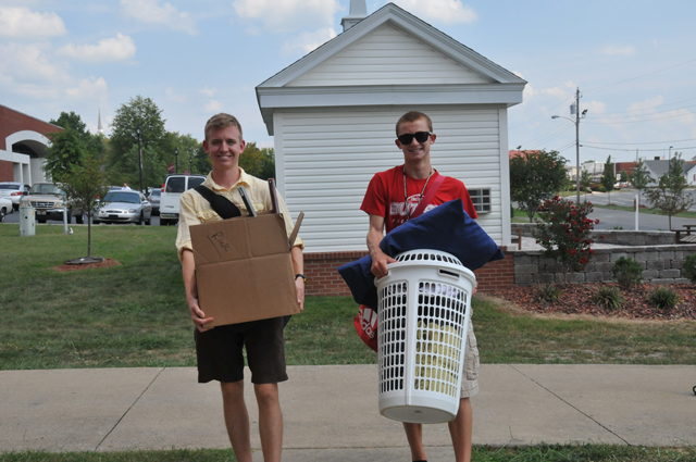 Garrett Baker, left, a senior of Bowling Green, Ky., helps freshman Joey Hartlage of Louisville, Ky., move into South Hall at Campbellsville University. (Campbellsville University Photo by Christina L. Kern)