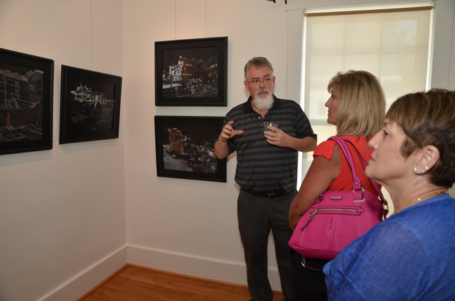 Bill Guffey, an artist from Burkesville in Cumberland County, Ky., explains his Google images to two of his art students, from left, Pattie Bryant of Burkesville, and Nancy Norris of Albany, during his opening reception. His work is on display at the Pence-Chowning Art Gallery through Sept. 12. (Campbellsville University Photo by Joan C. McKinney)