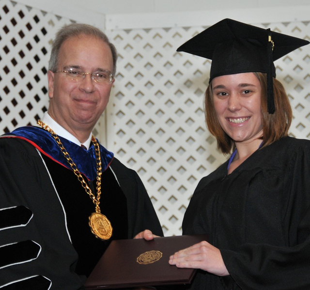Campbellsville University 2013 graduate Kayla Bradshaw from Greensburg, Ky. receives her diploma from President Michael V. Carter. In her Facebook post right before commencement, she wrote: “I’ve had an amazing experience at Campbellsville University. God blessed me with great professors and friends.” (Campbellsville University Photo by Joan C. McKinney)