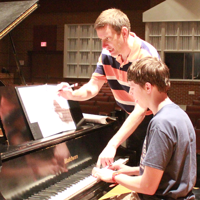 Dr. Bill Bubai, associate professor of piano studies, teaches a student piano during a one-on-one session. 