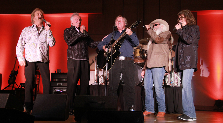 The Oak Ridge Boys surprised Buzz Cason, singer, songwriter and rock 'n' roll musician, while he was singing "Glory Bound" as the opening act for The Oak Ridge Boys concert at Campbellsville University's Ransdell Chapel Oct. 28. The Oak Ridge Boys are from left: Duane Allen, Joe Bonsall, with Cason, William Lee Golden and Richard Sterban. The group performed to a packed house and proceeds went to the university's Scholarship Fund. Cason is a member of the CCampbellsville University Board of Trustees. (Campbellsville University Photo by Rachel DeCoursey)
