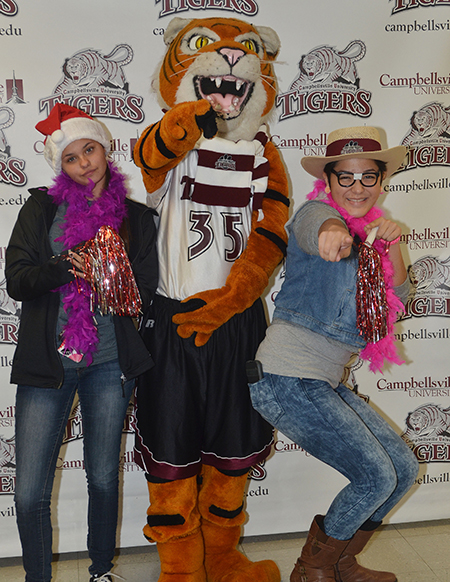CHS seniors Brooklyn Harris, at left, and Belen Garcia, at right, pose for a photo with Clawz.