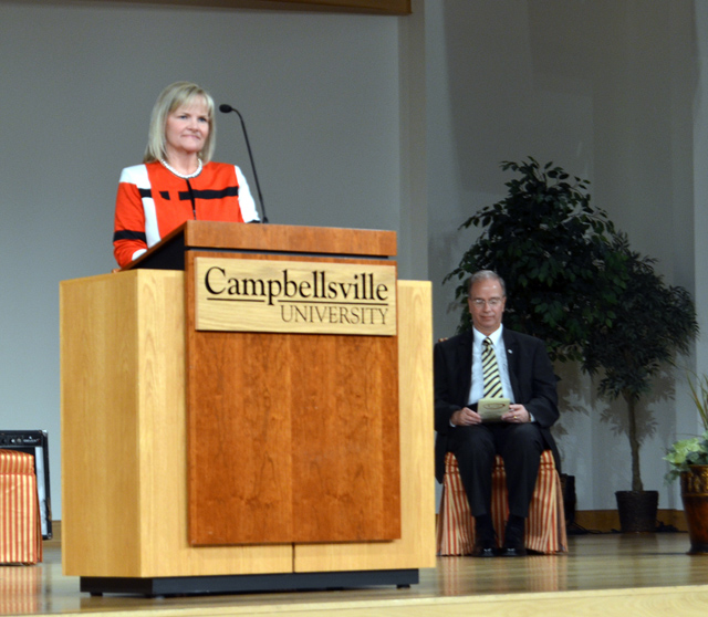  Carol Sullivan, director of CU's Technology Training Center, congratulates the graduates of the allied health program at a pinning ceremony. Dr. Michael V. Carter, president of CU, sits in the background. (Campbellsville University Photo by Meagan Pickett)