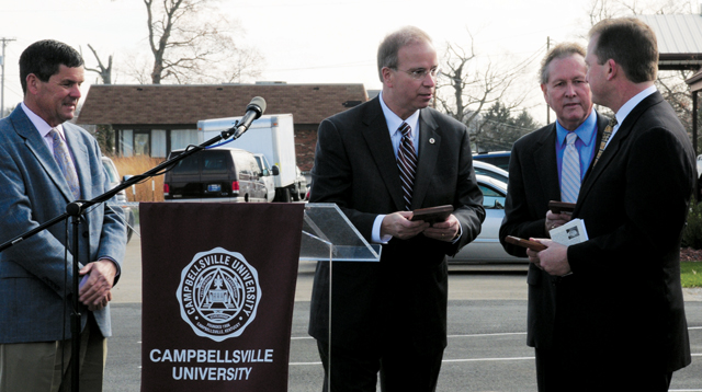 Freddie Hilpp, left, and Dr. Britt Brockman, far right, are presented with replicas of the plaques, which will be used on the Brockman building. Dr. Michael V. Carter, second from left, president of CU, was helped by Dr. Frank Cheatham, vice president for academic affairs, in presenting the gifts.(Campbellsville University Photo by Joan C. McKinney)