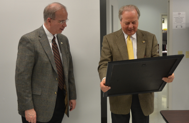 U.S. Congressman Ed Whitfield, right, (R-Ky.) looks at a new Campbellsville University academic/athletic poster given to him by Dr. Michael V. Carter, president of CU, left. (Campbellsville University Photo by Joan C. McKinney)