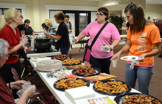 Cheris Young, right, director of women's residence village phase II and women's area coordinator, participates in the Hardees booth at Snack Attack Aug. 31 at the Banquet Hall. (Campbellsville University Photo by Nara Amarsanaa)