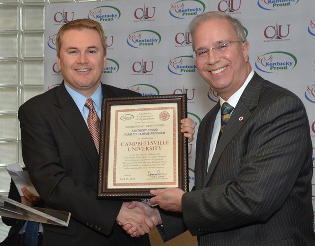 James Comer, left, Kentucky Department of Agriculture Commission, presents the Kentucky Proud Farm to Campus plaque to Dr. Michael V. Carter, president of Campbellsville University. CU is the  sixth university in the Commonwealth of Kentucky to join the program. (Campbellsville University Photo by Joan C. McKinney)