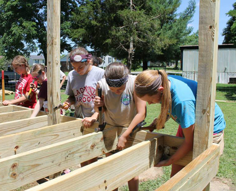 Volunteers begin assembling a deck for a homeowner in Campbellsville,  who had an unsafe entrance on his home before the crew arrived.  From left  are: Paige Oakley with Wellspring Community Church in  Liberty Township, Ohio, Kelsey Phelps, Carley Johnson, Jaley Broughton and Peyton Ingram, all with Eubank Baptist Church in  Eubank, Ky. (Photo by Lauren Barr)