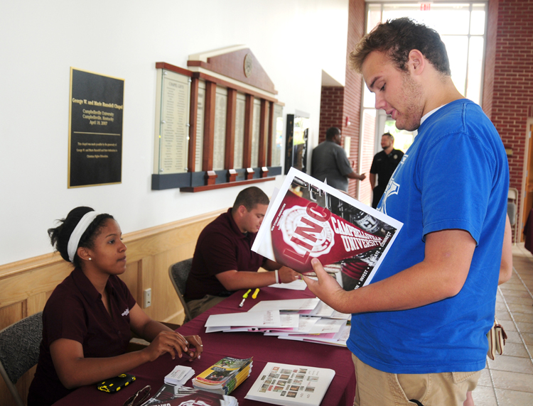 Michaela Parker, left, hands LINC information     to Drew O'Neil, an incoming freshman. (CU  Photo by Ellie McKinley)