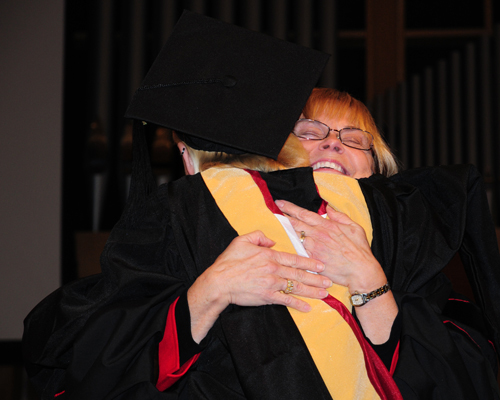 Dr. Darlene Eastridge, dean of the Carver School of Social Work and Counseling, hugs a graduate after she received her master's degree. (Campbellsville University Photo by Naranchuluu Amarsanaa)