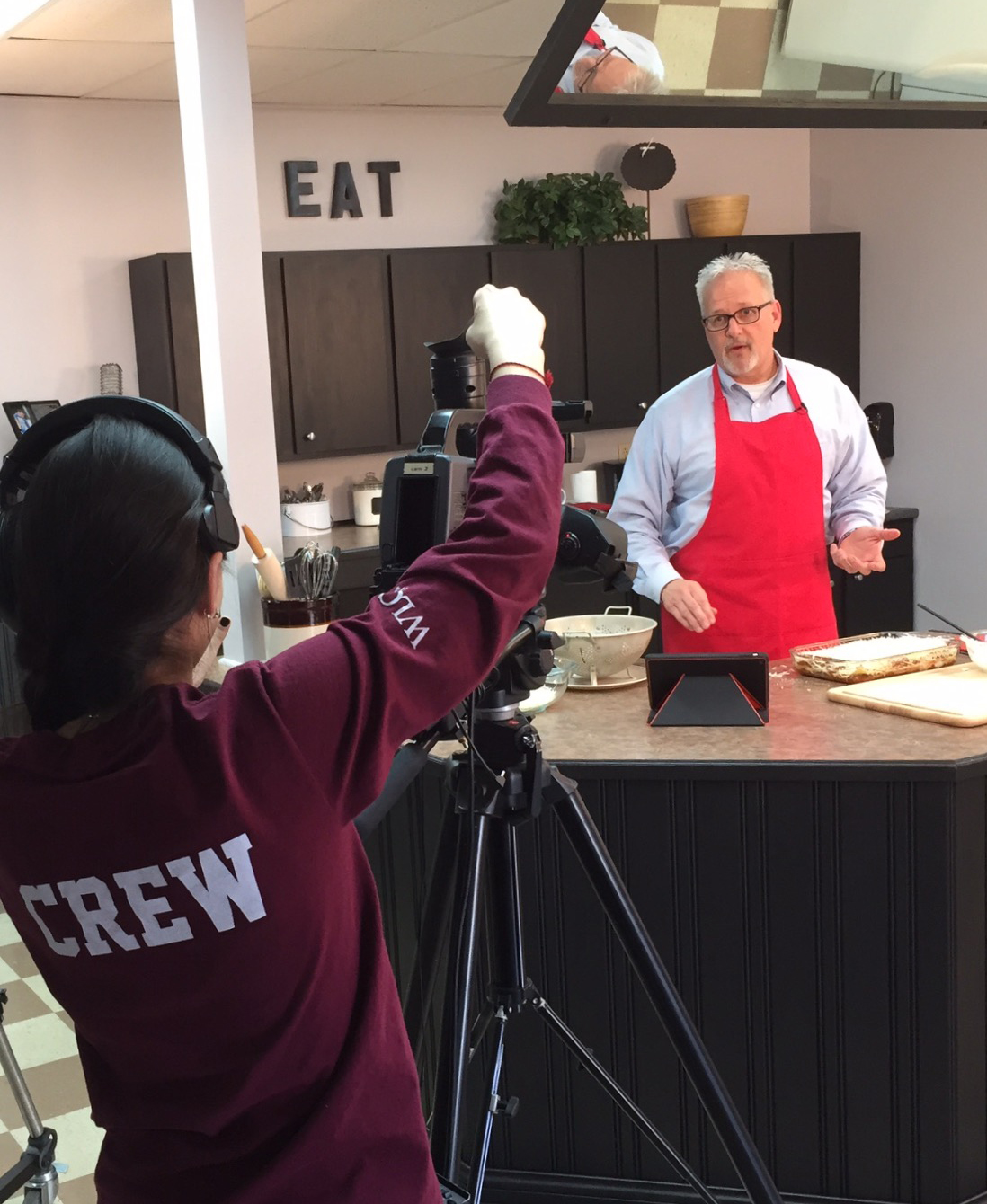  Dave Walters, vice president for admissions and student services, prepares a dish at WLCU-TV with camera person Purevzol "Akia" Batsuuri. Walters  is the new host of the "Cooking with Dave" show. (Campbellsville University Photo by Jeannie Clark)