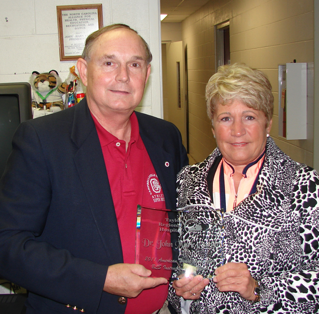 Dr. John M. Carter, professor of recreation and aquatics at Campbellsville University, receives the American Heart Association Basic Life Support Instructor of the Year Award from Jane Wheatley, chief executive officer of Taylor Regional Hospital, who is also a member of Campbellsville University’s Board of Trustees. ( Photo by Richard Phillips)