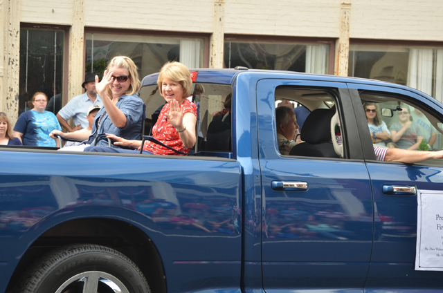 First Lady of Campbellsville University Debbie Carter, right, waves to the crowd at the July 4th parade along with Dr. Donna Hedgepath, vice president for academic affairs. Otto Tennant,  vice president for finance and administrator, drove the truck in the parade. 