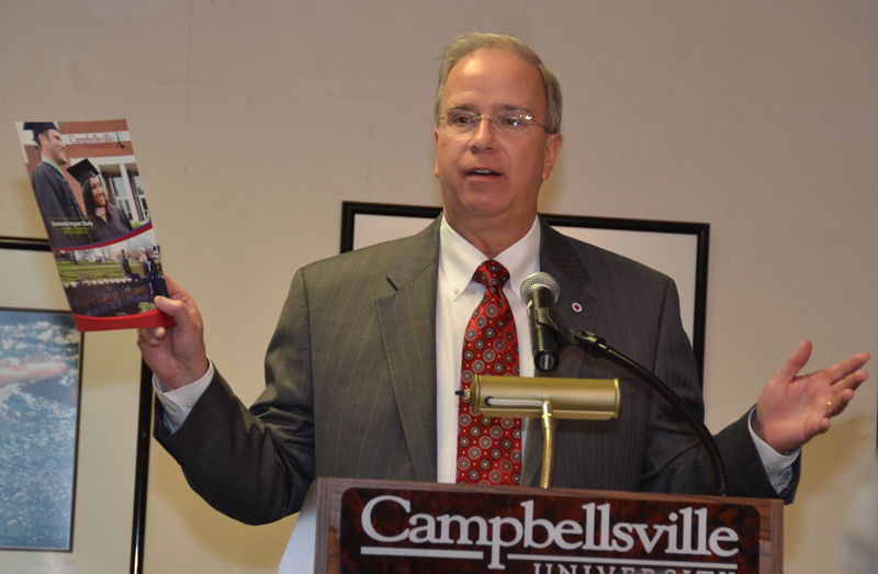 Dr. Michael V. Carter, in his 15th year as president of Campbellsville University, shows the Campbellsville/ Taylor County Chamber of Commerce, a recent economic impact story that shows CU contributed over $100 million in 2012-13 to the local economy. (Campbellsville University Photo by Drew Tucker)