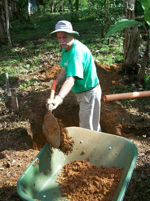 Ed Pavy, director of campus ministries, digs in  the dirt to make a hole for a plumbing line in  Costa Rica. (Campbellsville University Photo  by Alan Haven)