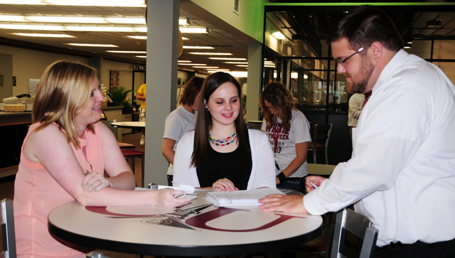 Emma Laster, left, and Ashlyn Carey, both of Franklin, receive room assignments from Tyler Arterburn at Campbellsville University's first LINC of the summer. (Campbellsville University Photo by Ellie McKinley)