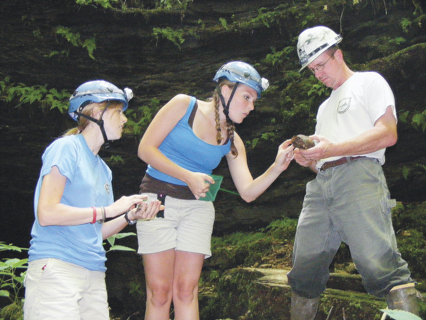 Environmental interns Amy Etherington, left, and Andrea O’Bryan study box turtles in Green County with U.S. Fish & Wildlife Biologist Chris Mason. (Photo by James Roberts, Central Kentucky News-Journal)