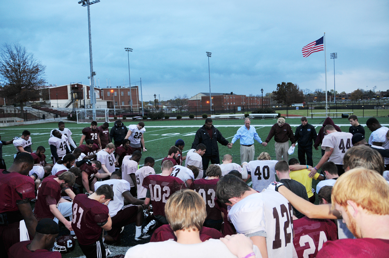 Members of the Campbellsville University Fighting Tigers Football Team said a prayer after receiving their "Life Books" from the Gideons and the CU Big Maroon Club. (Campbellsville University Photo by Ye Wei "Vicky")
