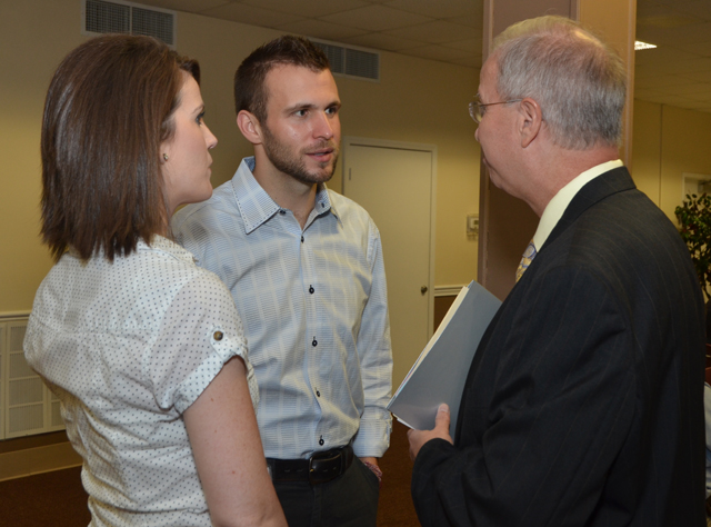 Eric Gilbert, center, will be the chapel speaker at 10 a.m. Wednesday, Sept. 4. He talks with Dr. Michael V. Carter, CU president, at the recent Church Relations Council meeting. At left is his wife Mandy. (Campbellsville University Photo by Joan C. McKinney)