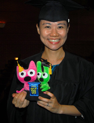 At left, Hsin-Jung Chang shows off a gift she received for earning her master of arts in music degree. (Campbellsville University Photo by Joan C. McKinney)  