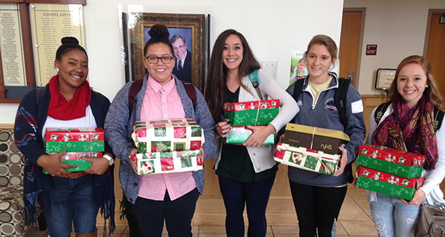 Students holding Operation Christmas Child Boxes