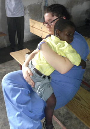 Lauren Barr, a sophomore of Brandenburg,  Ky., holds an orphan named Dave in Haiti.  Dave is sick and needs surgery so Barr gave  him what she could -- love.
